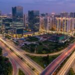 Modern glass skyscrapers residential towers West Hyderabad IT corridor twilight aerial view Golden Triangle cityscape