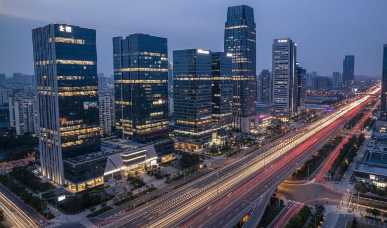 Aerial blue-hour view of Hitech City Hyderabad — modern glass IT towers, highways, high-yield real estate investment destination